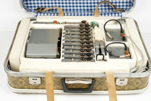 Sinitsa with plug-ins and accessories inside the suitcase